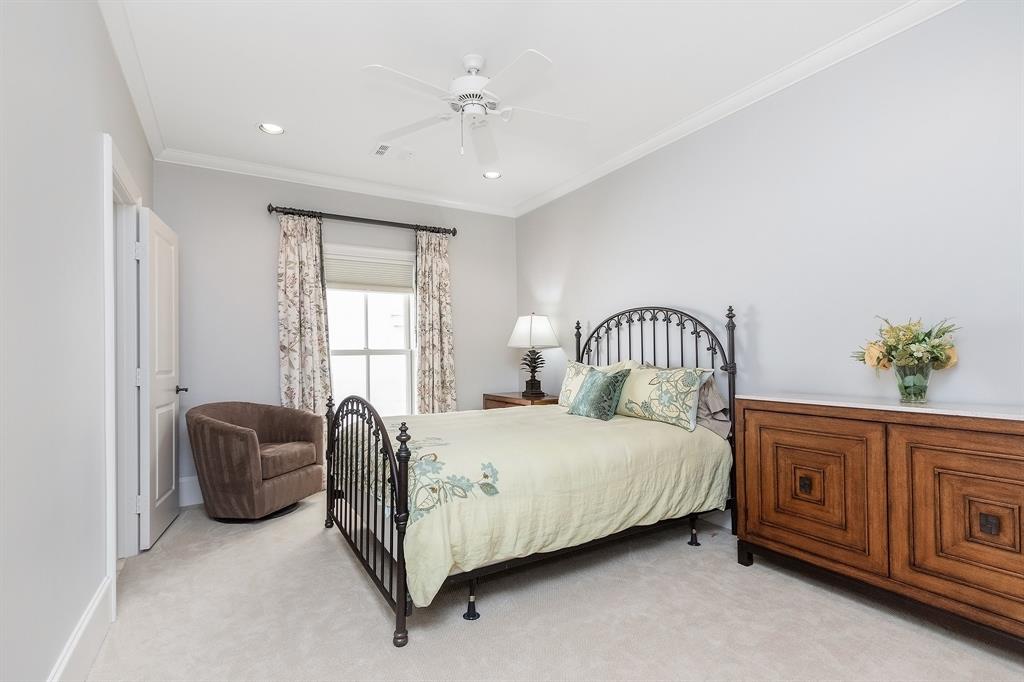 This charming bedroom features a large window, gorgeous natural lighting, and a ceiling fan. Larger pieces such as a standing dresser, bed, and armchair by the window can be accommodated here.