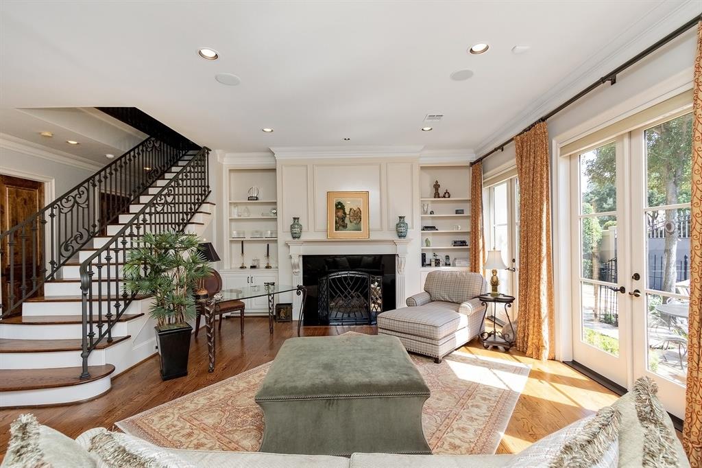 A fireplace brings more warmth into the interiors. A reading nook with a lay down sofa, lamp, and table can find a perfect spot by the glass doors.