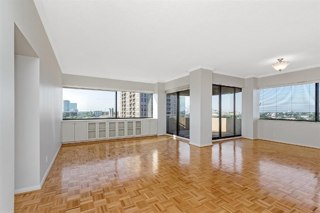 Nothing is more soothing than wide-open spaces, especially when engulfed with an unobstructed Houston cityscape view. Another angle showcasing the expansive dining area, living room, and balcony. This space opens up so many design opportunities!
