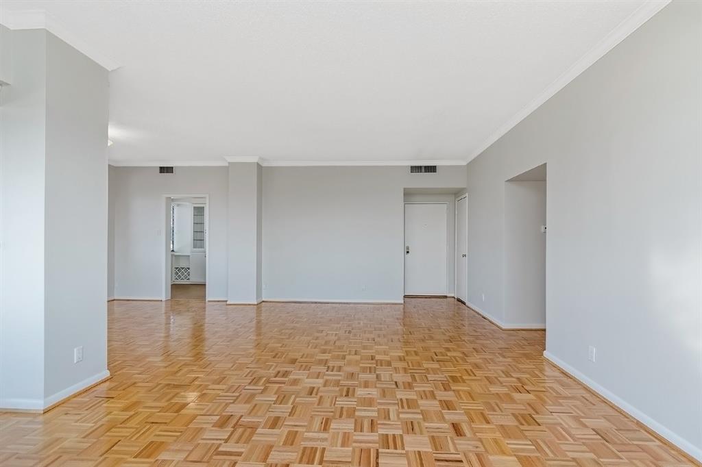 The crown molding and flawless wooden floors elevate the unit's overall ambiance. A spacious kitchen fully equipped with a plethora of cabinet storage and granite counter space is connected to the dining area. Attention to detail is found at every corner of this home.