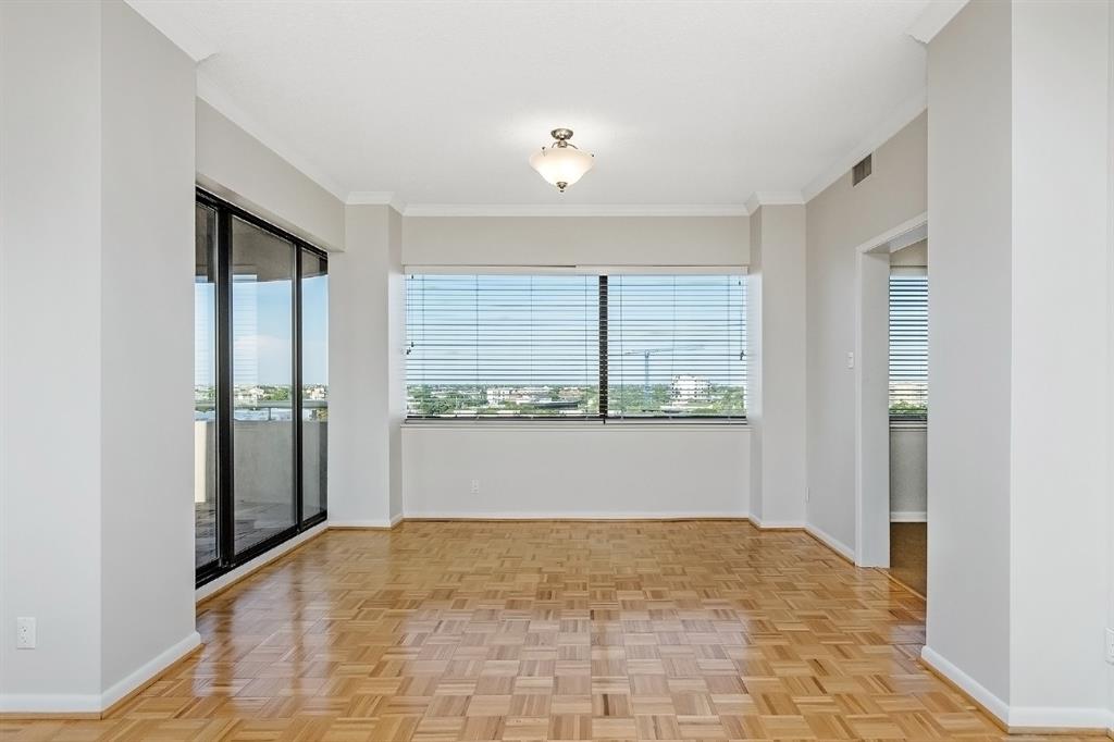 The dining area, adjacent to the kitchen, provides a great space for casual dining or entertaining friends & family. Views of the cityscape and the balcony are available from the large windows.