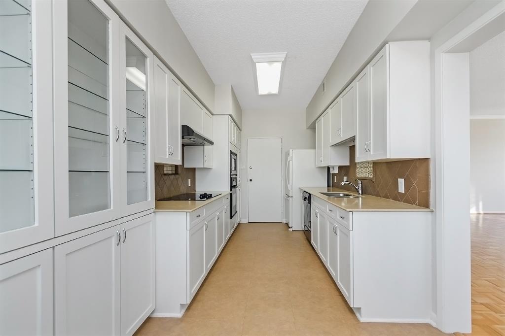 A stunning kitchen completely equipped with built-in cabinet storage, stainless steel sink, wall cabinets, appliances, and granite counter space. Every corner of this area is optimized to achieve its greatest functionality. Enjoy the ambient light coming from the window by the breakfast area.