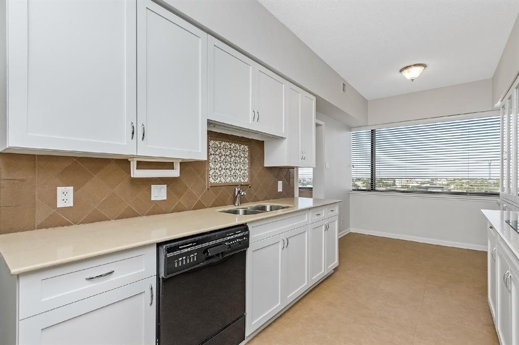 Miles of cabinet and countertops space make meal preparations easy and comfortable. Take note of the ambient light flooding in from the breakfast area through the large window.