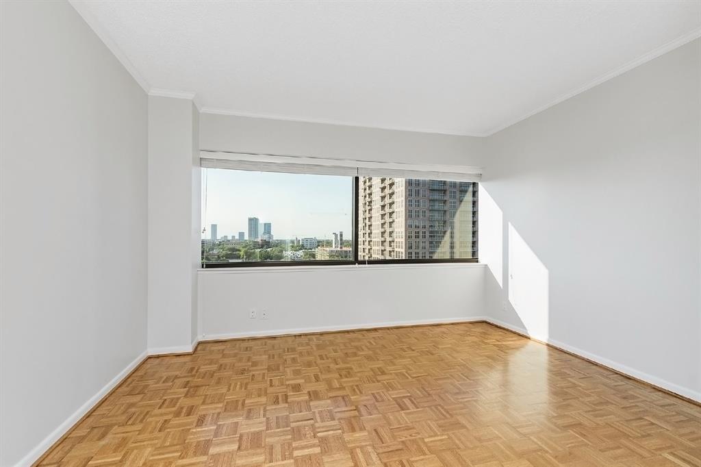 Serenity in the form of a bedroom, with its large windows, airy and well-lit space, and wooden floors. If you do not need the space for a bedroom, this would also be a great fit for an entertainment or game room.