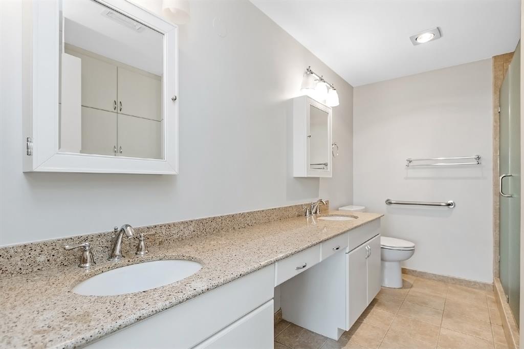 No limits to the luxury found in this unit! This magnificent bathroom features two sinks, two built-in mirrored medicine cabinets, and ceramic tile flooring surrounding a tub & shower combination. Not only is this a bathroom, but also a gorgeous enclosure with its stylish lighting and granite countertops.