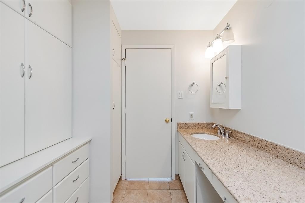 This unbelievable bathroom is bursting with both style and function including a top of the line wall of cabinetry, pull-out drawers, and medicine cabinets. Crisp white colors will add some pep in your step as you start your day.