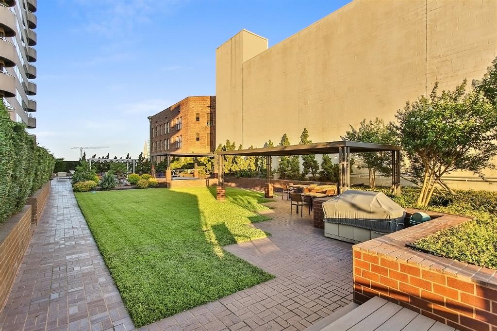 This sunny and lush oasis is ready for weekend hang-outs with friends and families. This view is of the incredible patio area with gazebos peeking over the large backyard green space, grilling area, and stunning pool.