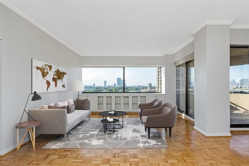 Another look at this stunning living area and the wonderful Downtown and Museum District view it provides. Custom-built shelves present excellent storage and space for decorations. Light and airy, the large windows allow moonlight to ease into the unit at night and sunlight to fill the space during the day.