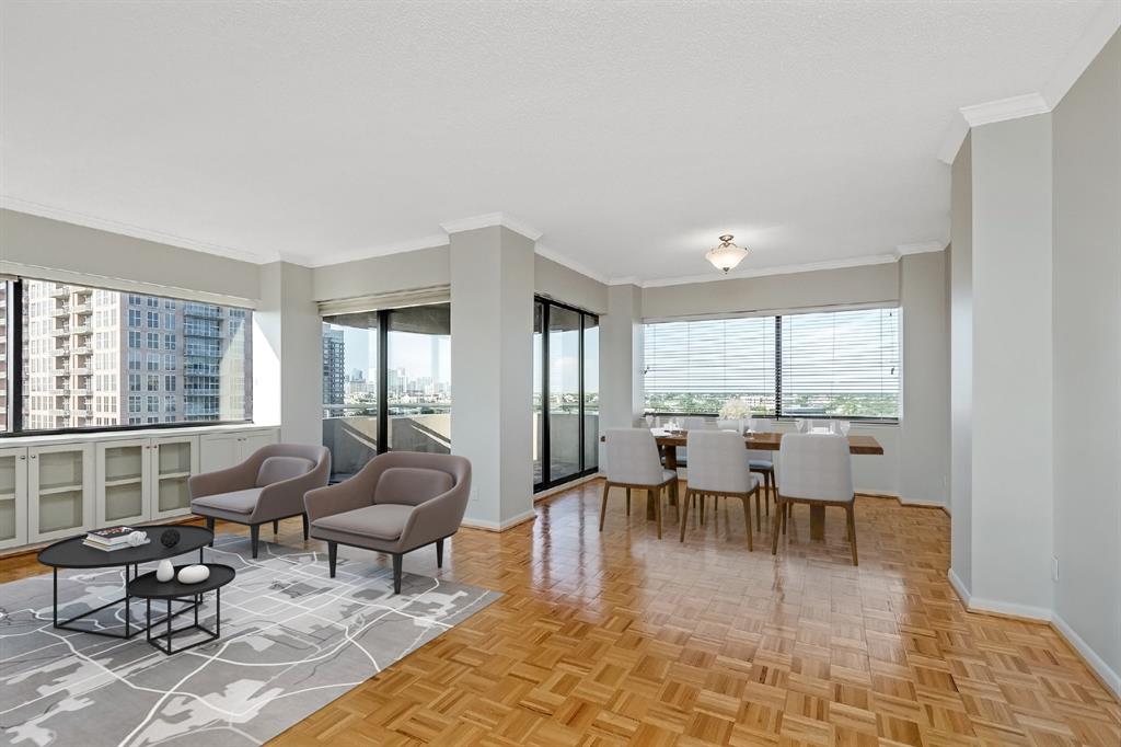 From this angle, you'll notice how exquisite the floor plan integrates the dining area and living space. Take note of the glass windows and sliding doors, which is yet another incredible feature of allowing the natural light to permeate the space. The taupe walls and black window panels tie together the fresh and minimal look of this space.