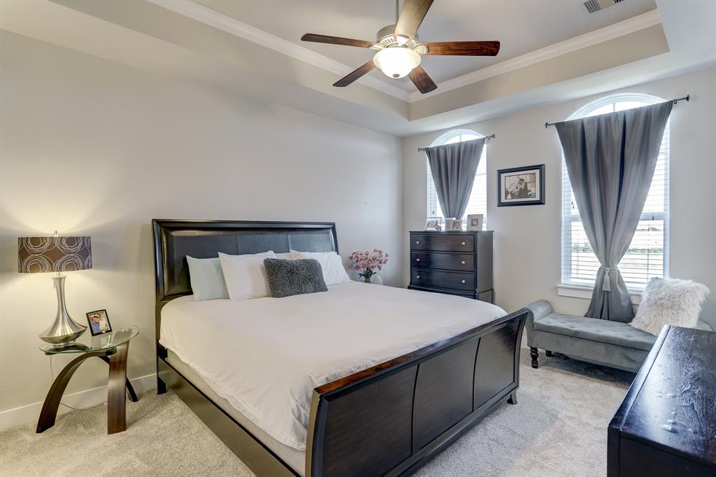 Feel relaxed and breezy as the intimate but spacious primary room features a ceiling fan with a light fixture, lush carpet flooring which matches the bright hued-walls, and huge windows that allow an abundant amount of sunlight to fill the expanse of the room during the day.