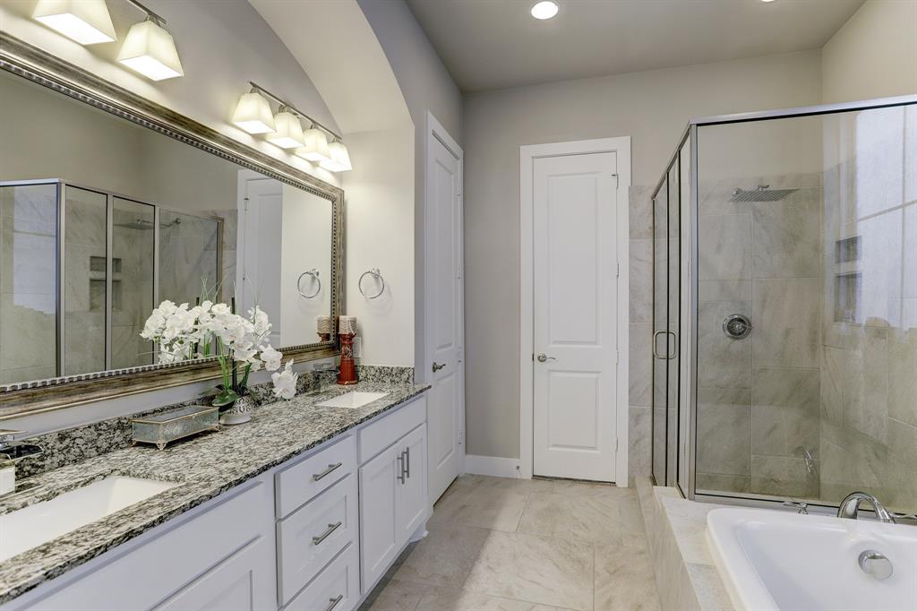 Stepping into the primary bath is euphoric. With a tub perfect for a relaxing soak, separate glass-walled shower, a huge stunning granite double sink, a massive vanity mirror, and plenty of cabinets for your bathroom essentials, this primary bath has everything you need to start and end your day.