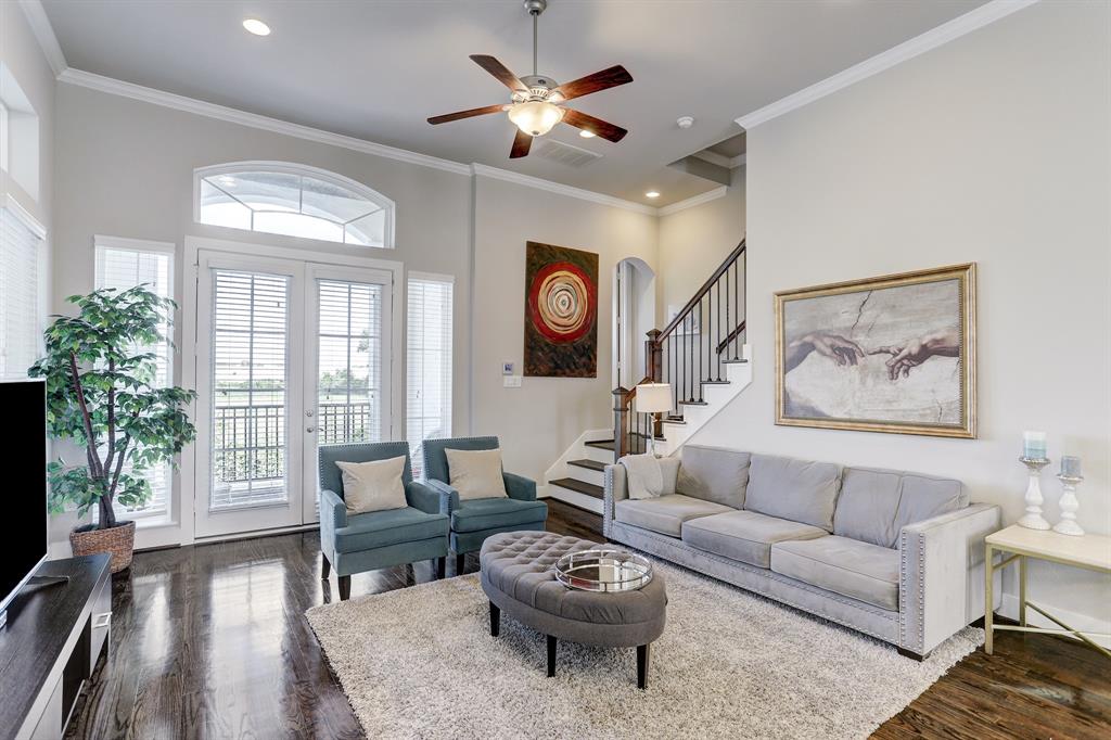 The entire space is designed with high ceilings with recessed lights and a classy ceiling fan with a light fixture that supplement its sophisticated appeal. Adding to the living space's charm are the two beautiful French doors and long large windows which let natural light flow seamlessly inside. Outside the doors is a balcony overlooking the surrounding views of the neighborhood.
