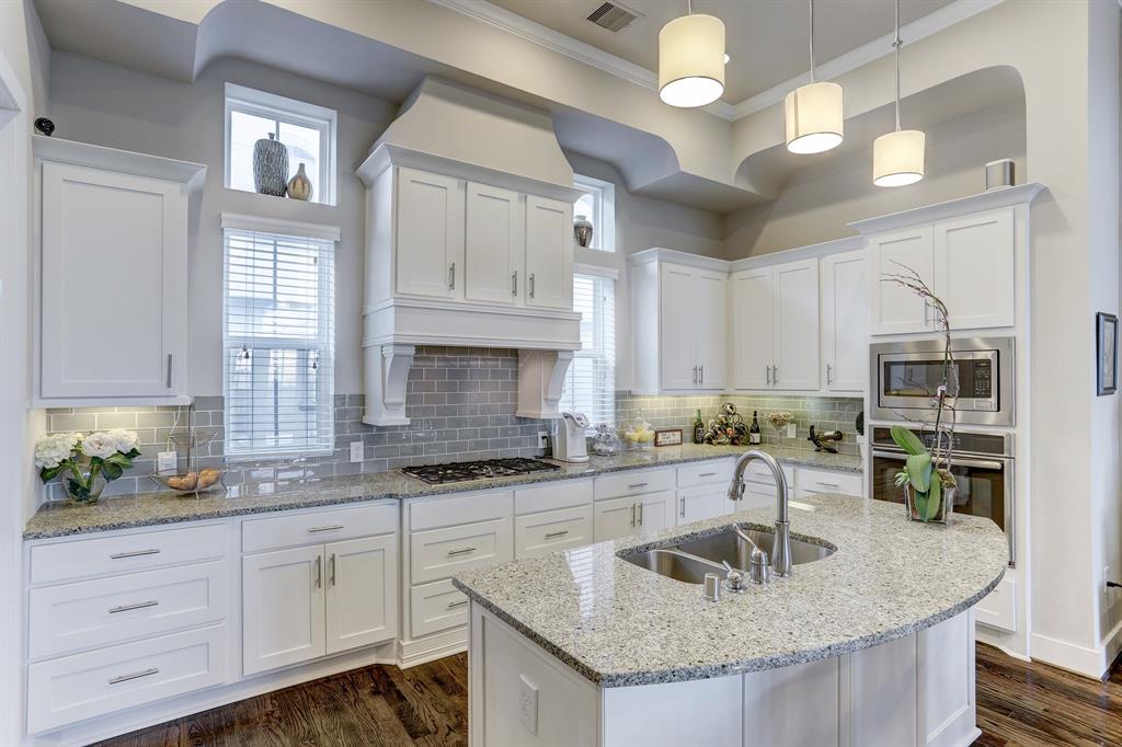 This stunning kitchen will spark your inner chef with its granite counters, center island with double sink, and stainless steel appliances. This state-of-the-art kitchen is filled with tons of cabinet, perfect for storing cooking essentials! Pendant lighting and under-cabinet lighting provide brightness and extra visibility for your culinary endeavors.