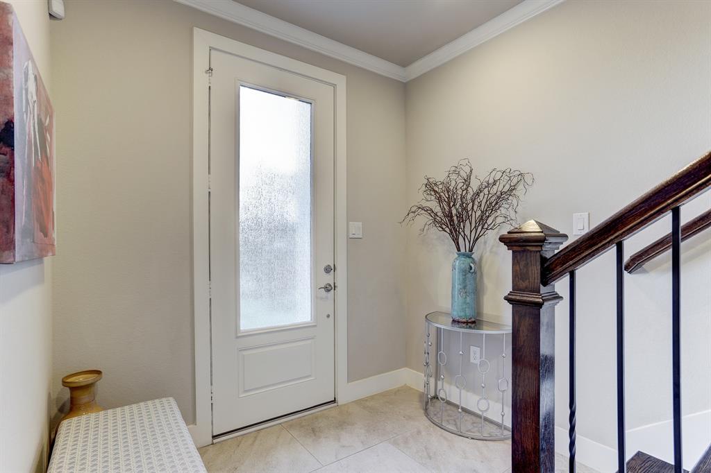 Enter through a stunning panel half-glass door and you will be welcomed by stairs with gorgeous hardwood handrails. The door allows natural light to flow through the lovely tiled-floor that perfectly complements the bright hued-walls.