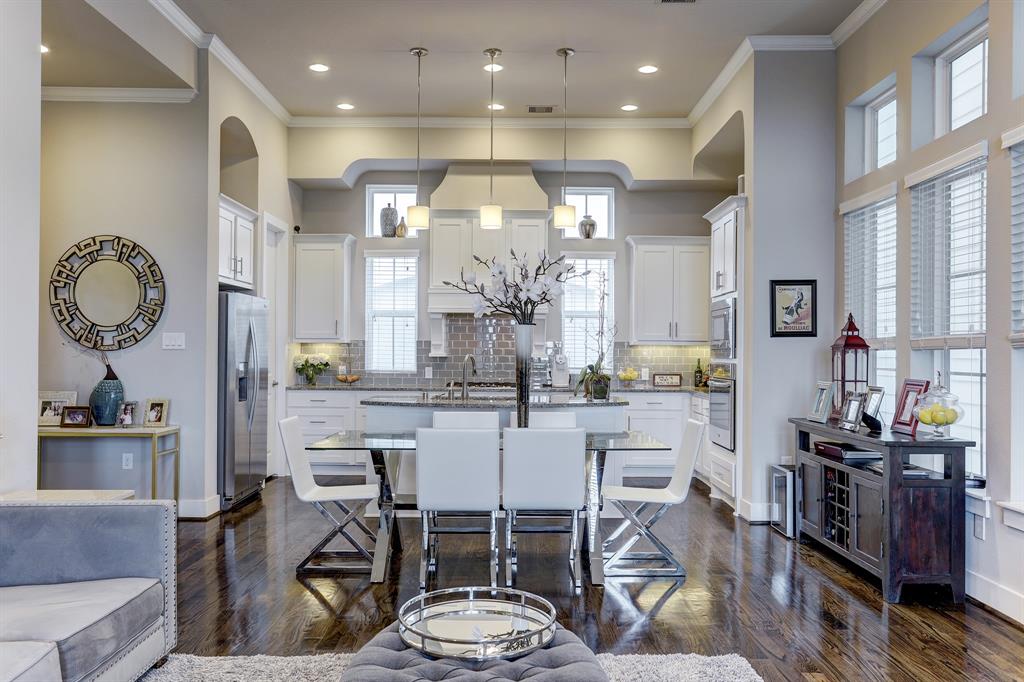 No need to worry about grabbing a bite or a drink as the dining and kitchen areas are just a few steps away. Thanks to the perfectly planned open floor plan, the dining area is perfectly situated between the living area and the kitchen. The perfectly installed hardwood-floor ambiently complements the bright hued-cabinets and walls.