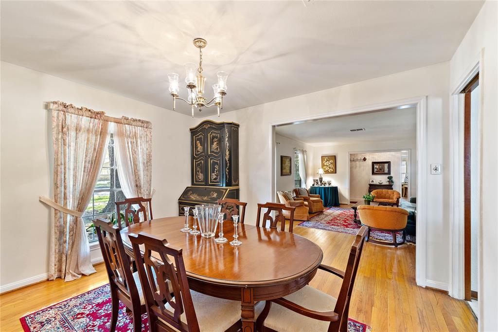 The sophisticated dining area is also graced by a generous high-level window, draped with intricate curtains. With its dazzling chandelier, this sit-down space is the perfect spot to indulge in delectable, well-lit meals. Natural light effortlessly bounces off the walls to invite brightness into your home.