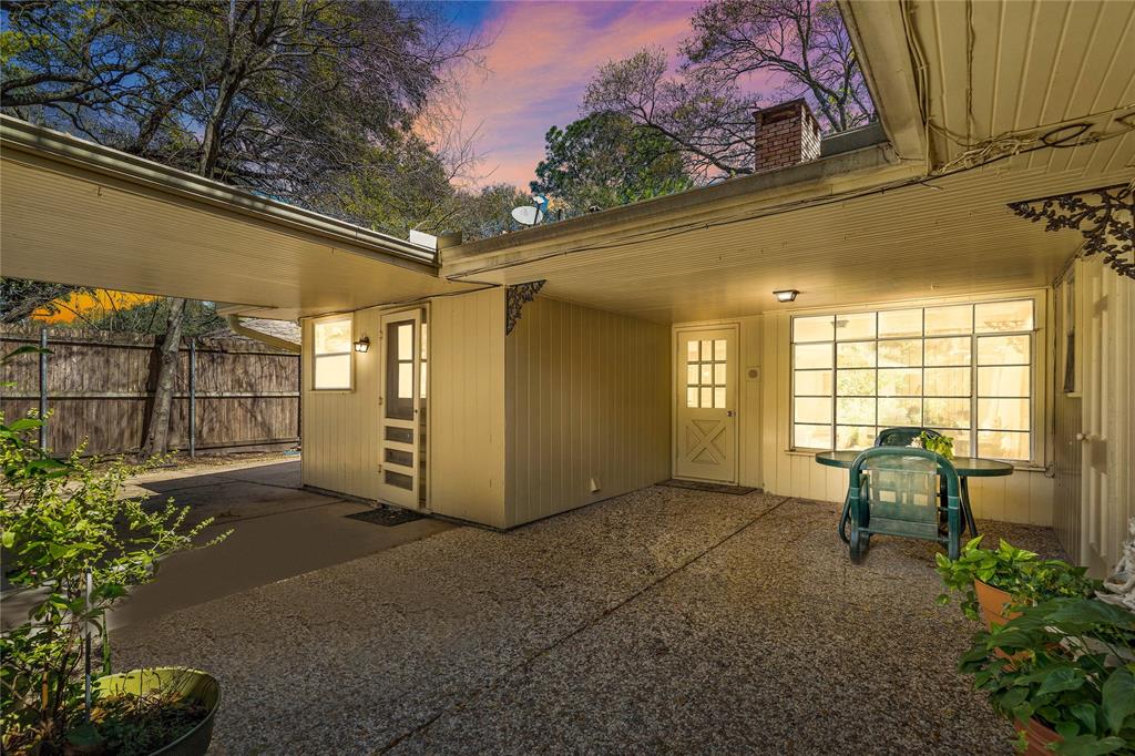 The backyard of this home is just as precious as the front. Enjoy any weather on your stone patio while enjoying your cup of tea or coffee. This area features a covered walkway from the laundry room to the garage.