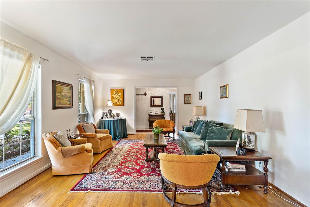 The formal living room offers a light and bright ambiance that features wide-reaching windows and unsullied walls that flood the room with luminosity. Hardwood floors course throughout this ideal home from corner-to-corner.