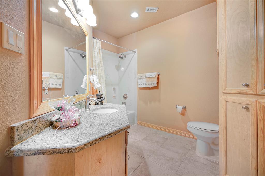 Secondary full bath situated close to secondary bedrooms has all the details - custom wood vanity with granite tops, framed mirror, builtin linen closet and added extra wall hung cabinets.