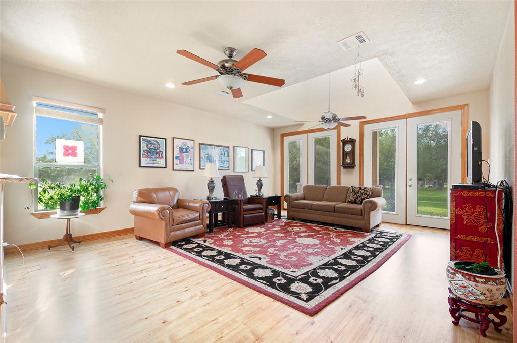 Roomy and bright ! Family room reveals lots of space and natural lighting - including a skylight area located just over the sofa. French door leads to front sitting porch. Kitchen is close giving an open concept feel.