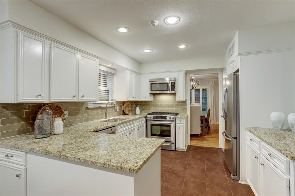 Granite counters with stainless appliances.  The refrigerator will convey with the sale.
