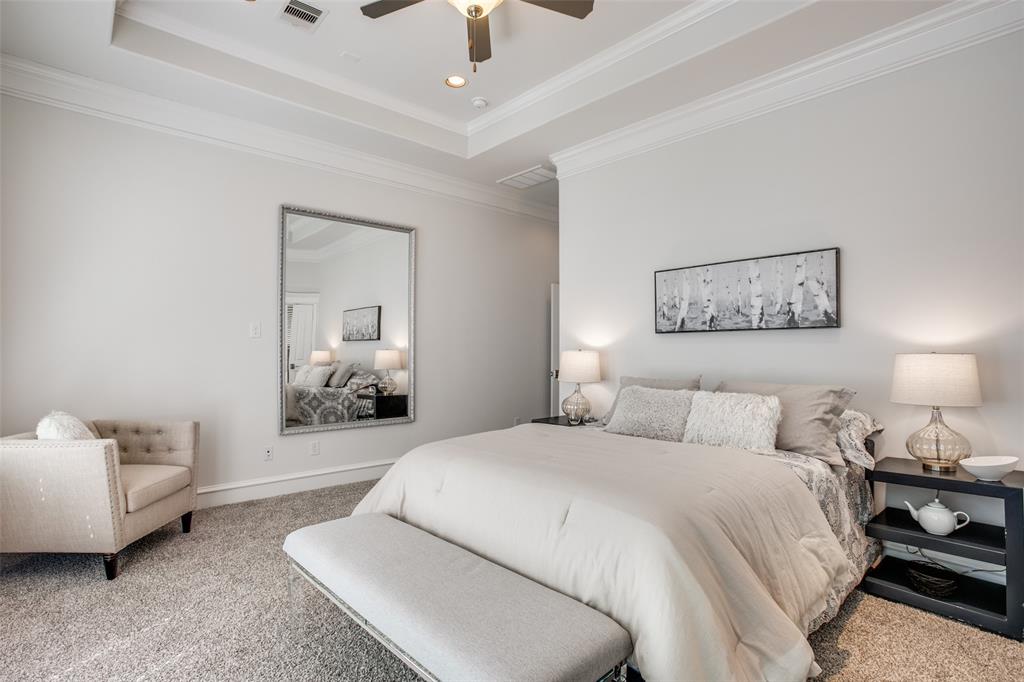 A raised tray ceiling makes this bedroom seem even larger!