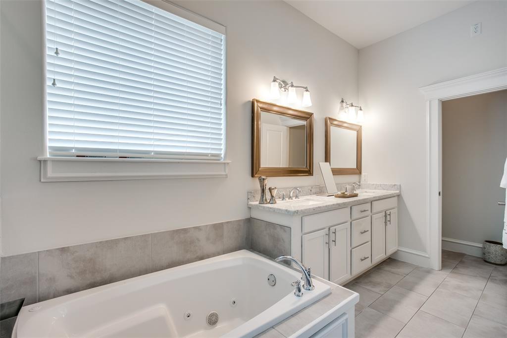 Double sinks with plenty of storage. Jetted tub and separate WC.