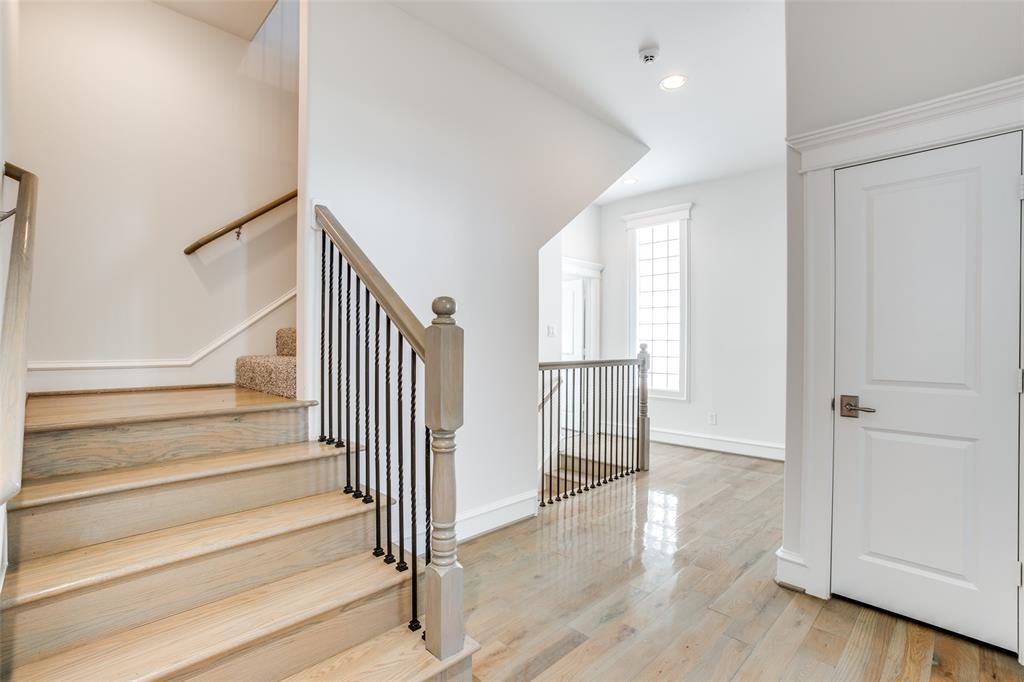 This photo shows a hall closet on the right, and also the stairs leading to the bonus room on third floor.