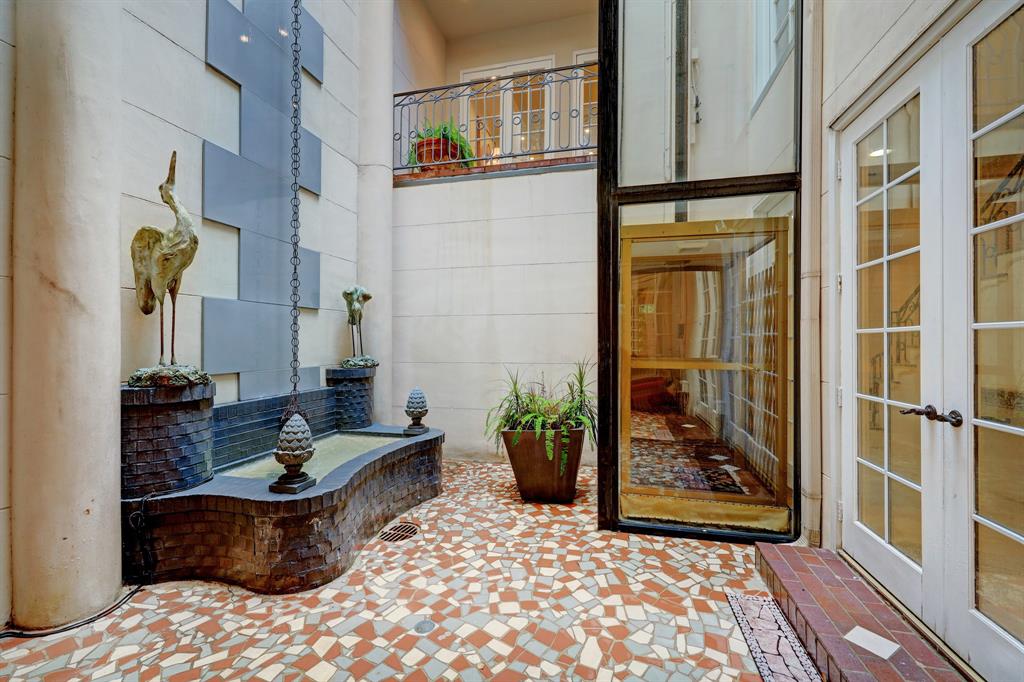 Photo #12 Imagine the french doors open and the soft sound of water trickling down the fountain feature, filling the atrium and the home throughout!