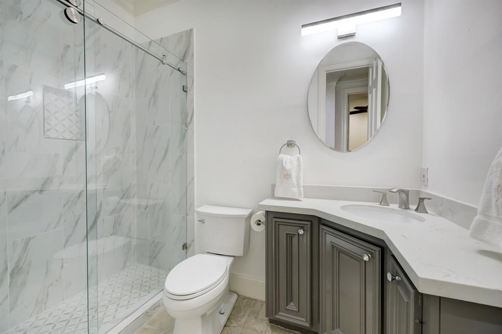 Photo #9 Recently updated full bath downstairs features a walk-in shower and updated vanity.