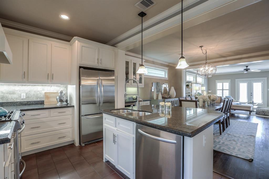 Center-island kitchen features granite counter tops, stainless steel appliances and lots of storage