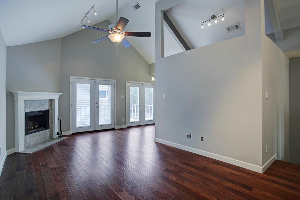 Charming two-story Heights patio home with stylish updates throughout, open floor plan and flex room. High ceilings, an elegant fireplace and track lighting make this a great space to entertain.