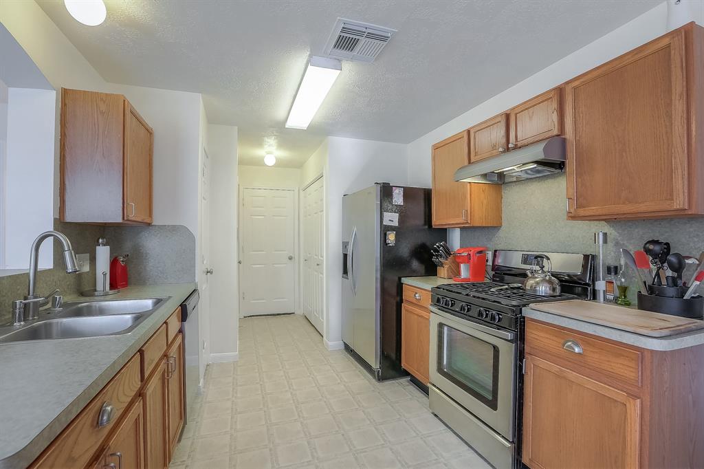 Plenty of storage in this useful galley-style kitchen! Kitchen leads to laundry room, the 1/2 bathroom, laundry closet and 2 car garage.