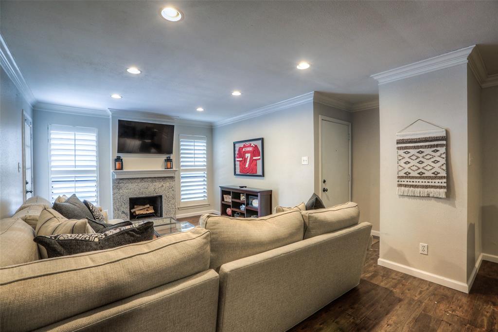 Living areas feature wood floors, crown molding and recessed lights.