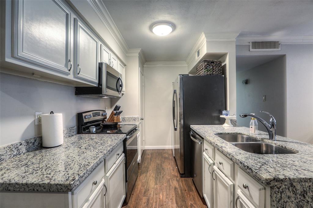 The kitchen features granite counter tops and recently installed stainless steel appliances.