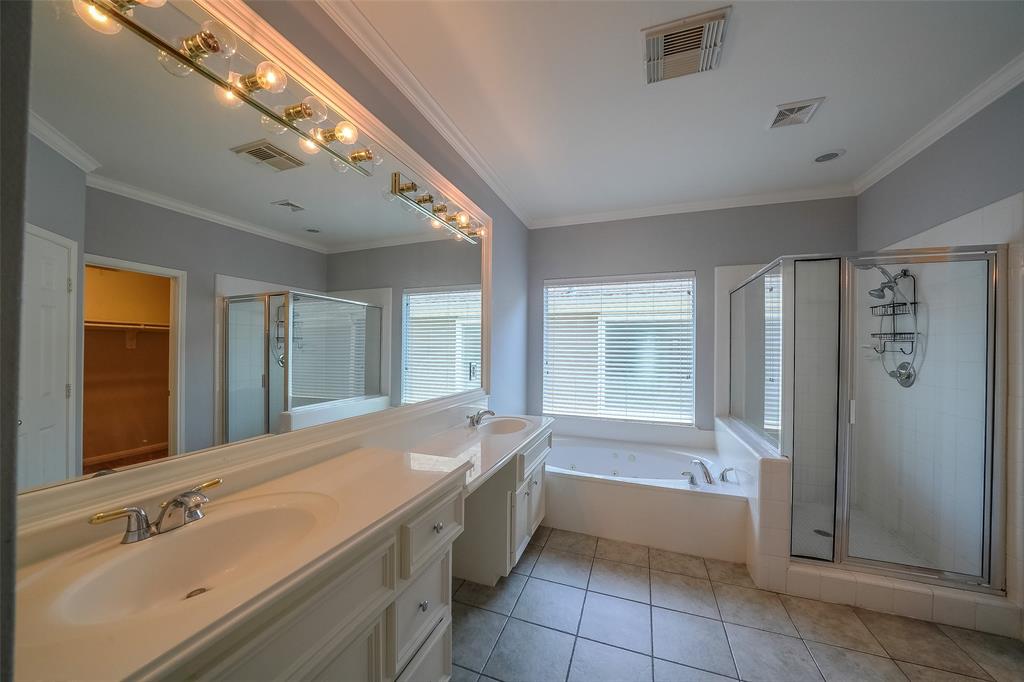 Master bath equipped with separate shower, jetted tub, and double sinks