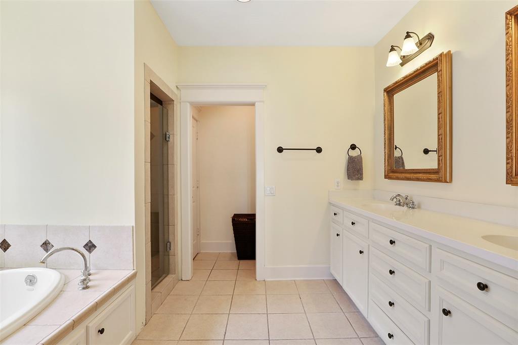 Master bath with large tub, shower, and double vanities.