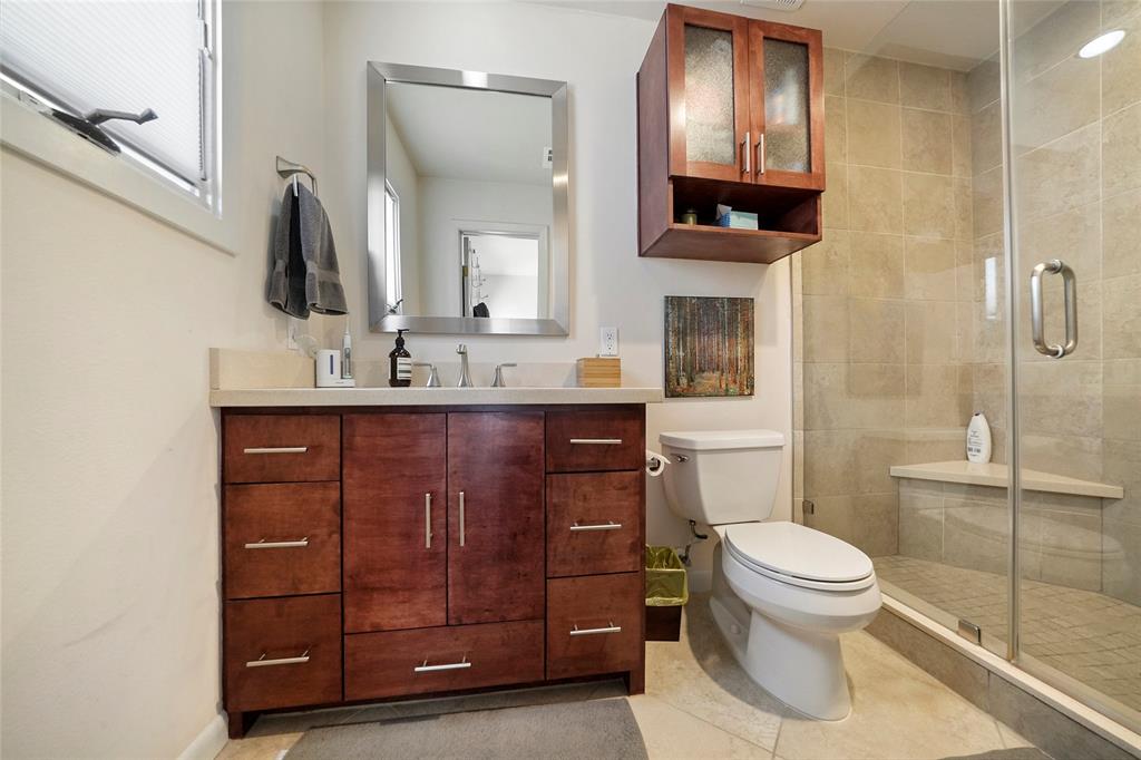 A look into the handsome features and decor of the master bath. That shower is considerable and has a seat!