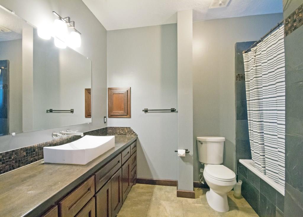Master bath has over sized soaking tub with shower and lots of storage