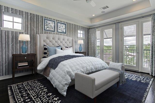 The master bedroom is finished in neutral hues, custom window treatments, and subtle wallpaper on the north wall.  This room has been virtually staged.