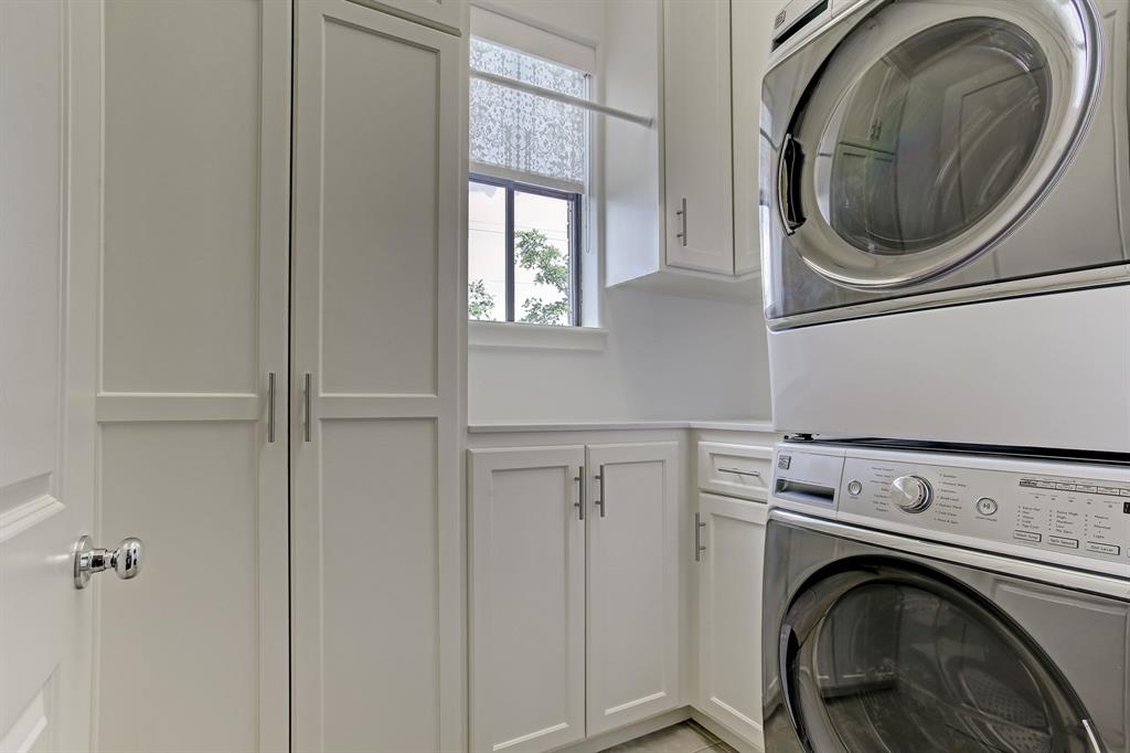 This true laundry room offers additional cabinet and storage space. Washer and dryer are included.