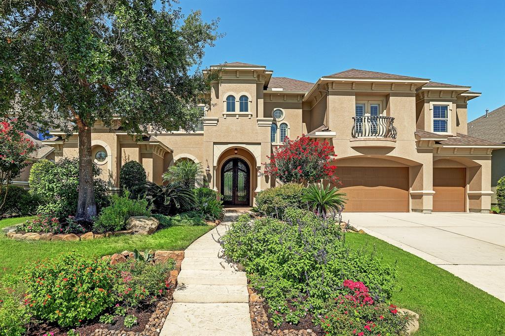 7414 Dayhill Dr Drive Spring, Texas Stunning Mediterranean custom home in the exclusive gated Champion Woods Estates. House was awarded the 2012 PRISM Award by GHB.This home is ready for immediate move-in.This property boast gorgeous professional landscaping and custom 10ft. steel double wrought iron doors greet you as you approach the property.Interior features include dramatic two story foyer, hand bent custom spiral wrought iron staircase, custom chandeliers, walls of glass windows, crown molding, formal dining, study, nice size master suite, master bath with Jacuzzi tub and walk in shower, dual heads, two bedrooms down.Chef's kitchen with upgraded Pro Style appliances by Jenn Aire, 48 in. built in refrigerator, two large islands, dual convection ovens, Jenn-Air 6-burner gas range, media room, two surround sound systems.Exterior features include outdoor kitchen and living area, gorgeous pool, travertine decking surrounded by lush landscaping. Don't miss the upgrade sheet attached to see all this home offers!