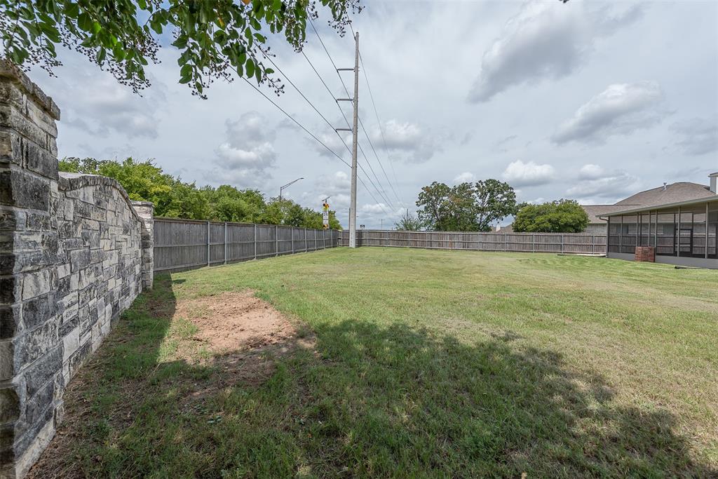 This backyard backs up to the Bridle Gate Estates main stone entrance that faces Longmire Drive.