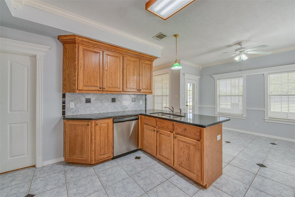 Just to the left of the sink area is a doorway leading to a separate utility room.