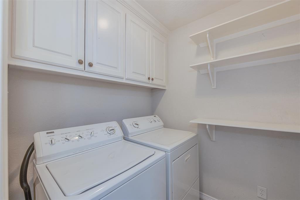 With its overhead cabinets and built in wall shelving, the separate utility room can be utilized for more than just laundry. Bonus: the washer and dryer convey.