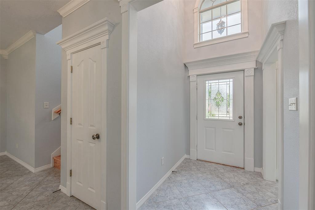 This gorgeous glass door with ornate chandelier overhead makes for an inviting and extravagant entrance.