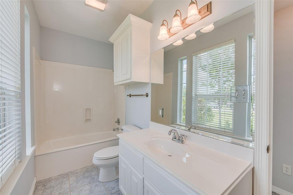 Just off the family room and entry is the first of the home's full baths.