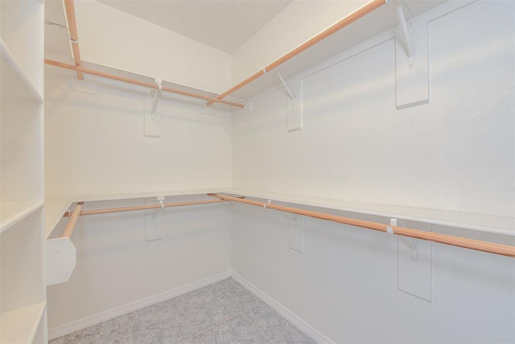 An oversized walk-in closet, just off the ensuite, has an abundance of hanging room AND, for the shoe enthusiast, shoe shelves.