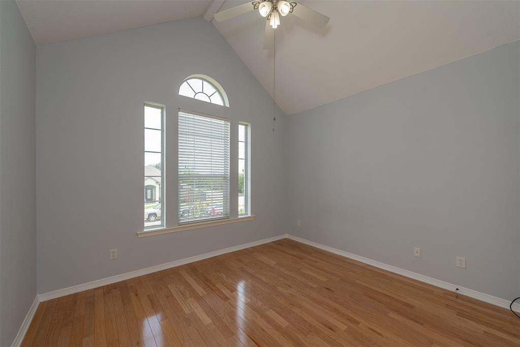 Located just off the left side of the game/media room is a bedroom that features a vaulted ceiling.