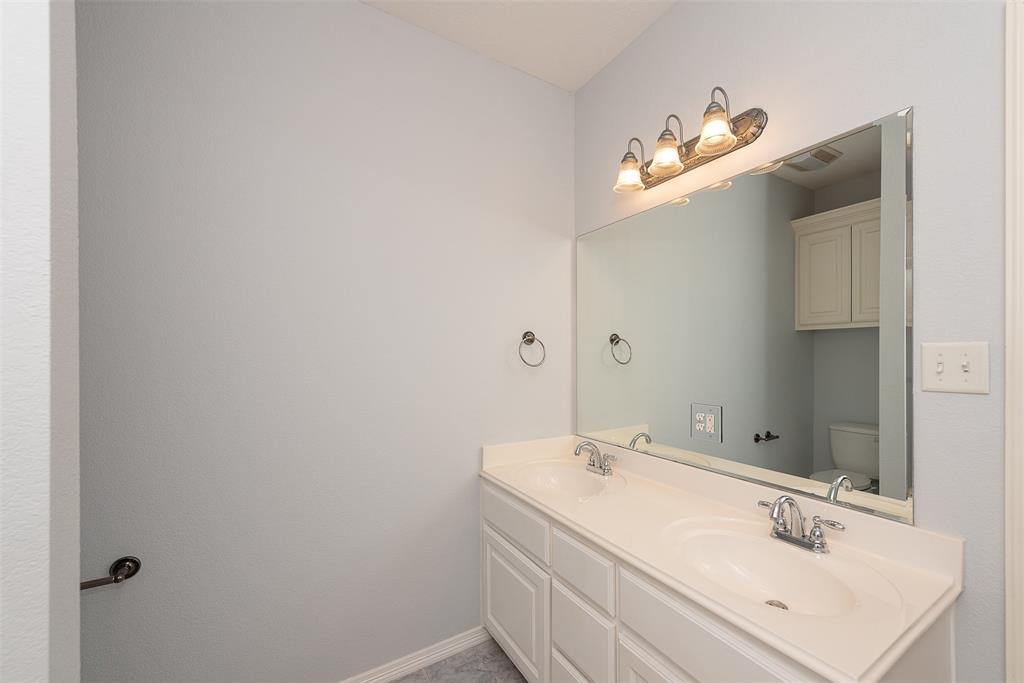 The dual vanities in this second full bath give each guest their own separate sink space.